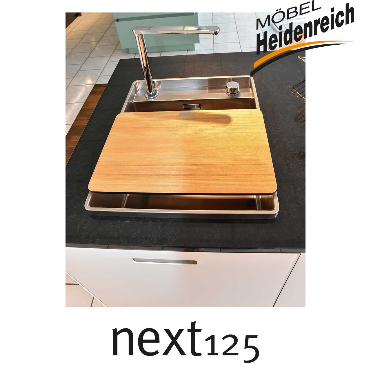 Detailansicht der Edelstahlspüle mit Holz-Abdeckplatte darüber.